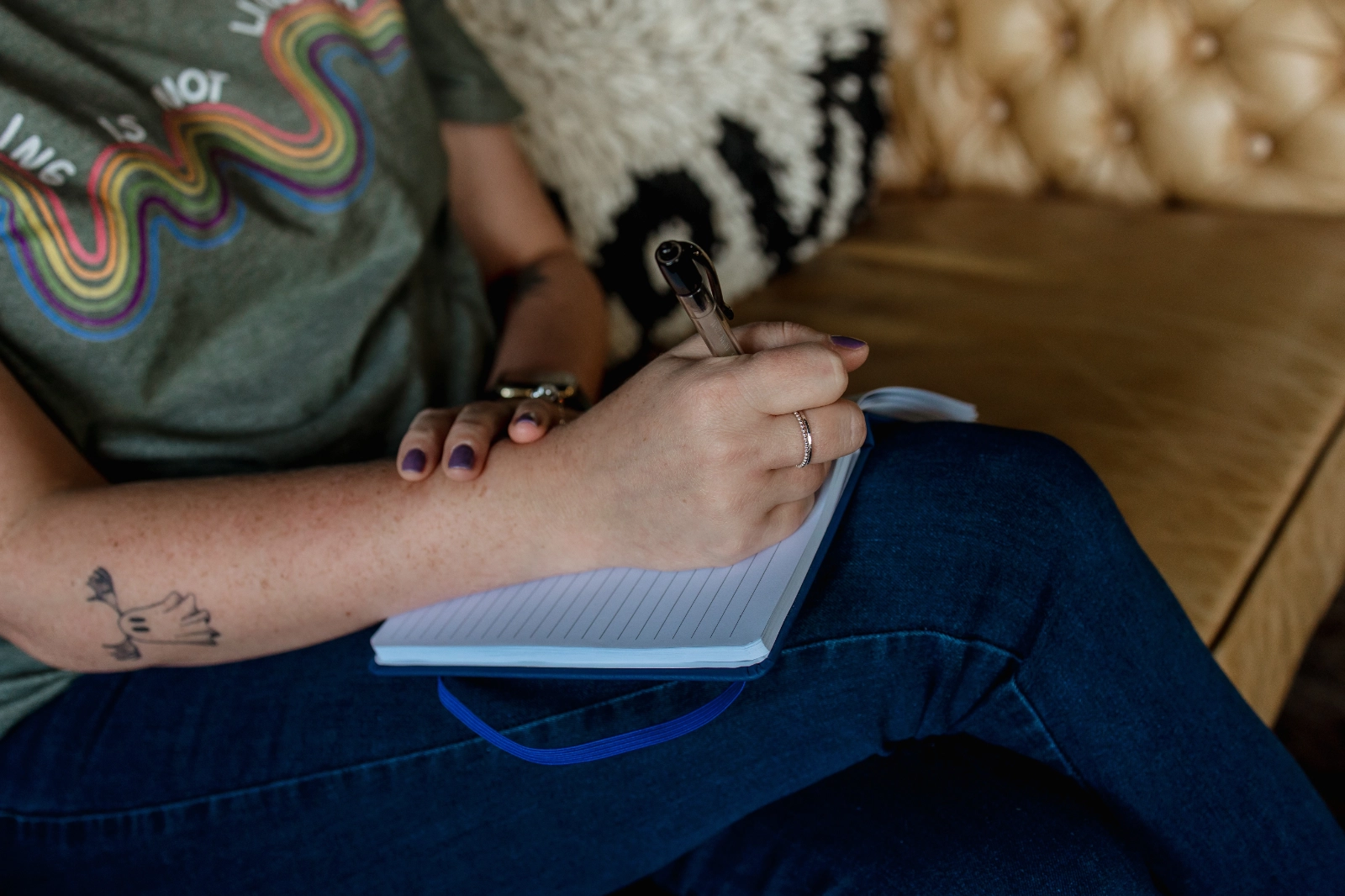 a photo of a person writing in a notebook